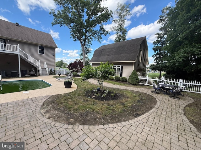12534 Fawn Dr, Laurel, DE 19956 - view of community featuring a patio area, a swimming pool, stairway, and curved driveway