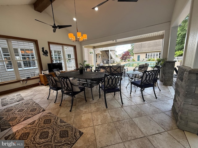 12534 Fawn Dr, Laurel, DE 19956 - dining area featuring stone tile floors, beamed ceiling, a chandelier, healthy amount of natural light, and high vaulted ceiling