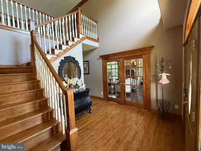12534 Fawn Dr, Laurel, DE 19956 - stairs featuring wood finished floors, french doors, and a towering ceiling