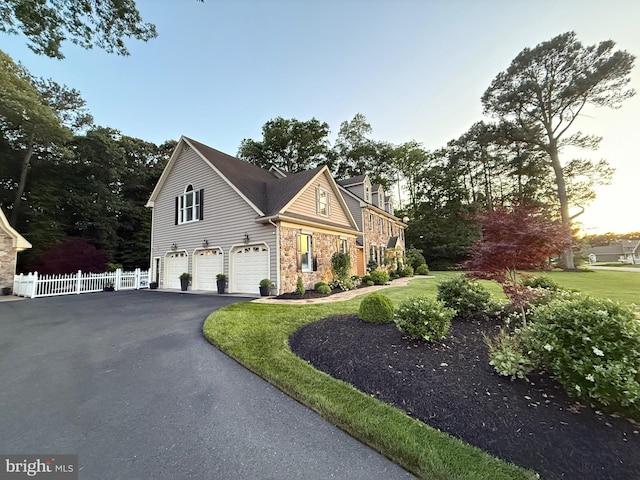 12534 Fawn Dr, Laurel, DE 19956 - view of front facade featuring an attached garage, stone siding, and driveway