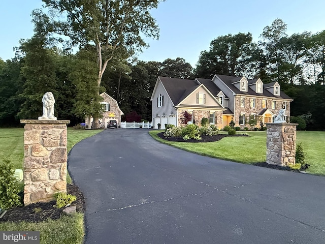 12534 Fawn Dr, Laurel, DE 19956 - view of front of house with a garage, stone siding, asphalt driveway, and a front lawn