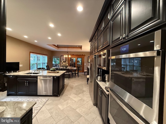 12534 Fawn Dr, Laurel, DE 19956 - kitchen with appliances with stainless steel finishes, dark cabinetry, pendant lighting, recessed lighting, and light stone countertops