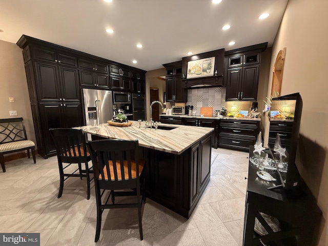12534 Fawn Dr, Laurel, DE 19956 - kitchen with appliances with stainless steel finishes, dark cabinets, tasteful backsplash, a breakfast bar, and recessed lighting