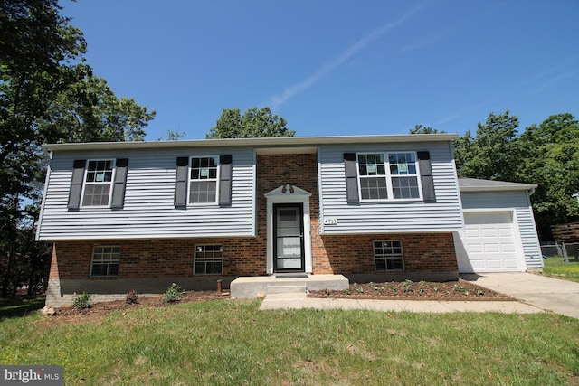 4713 Akron St, Temple Hills, MD 20748 - raised ranch featuring driveway, a front lawn, an attached garage, and brick siding