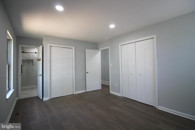 4713 Akron St, Temple Hills, MD 20748 - unfurnished bedroom with two closets, dark wood-style flooring, baseboards, recessed lighting, and ensuite bath