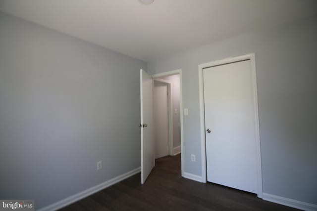 4713 Akron St, Temple Hills, MD 20748 - unfurnished bedroom with dark wood-style flooring and baseboards