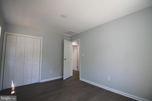4713 Akron St, Temple Hills, MD 20748 - unfurnished bedroom featuring attic access, dark wood-type flooring, baseboards, and a closet