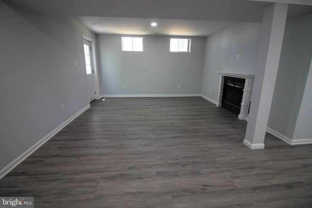 4713 Akron St, Temple Hills, MD 20748 - basement with a fireplace, baseboards, dark wood-style flooring, and plenty of natural light