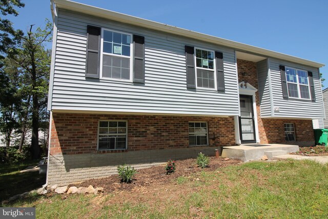 4713 Akron St, Temple Hills, MD 20748 - view of front facade featuring brick siding and a front lawn