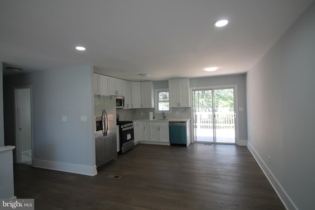 4713 Akron St, Temple Hills, MD 20748 - kitchen with appliances with stainless steel finishes, a sink, light countertops, baseboards, and white cabinets