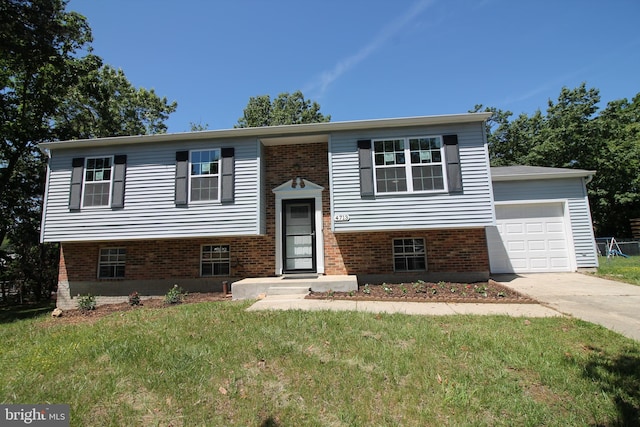 4713 Akron St, Temple Hills, MD 20748 - bi-level home featuring concrete driveway, a front yard, an attached garage, and brick siding