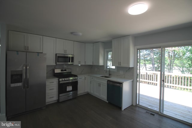 4713 Akron St, Temple Hills, MD 20748 - kitchen with stainless steel appliances, light countertops, white cabinets, and dark wood-style floors