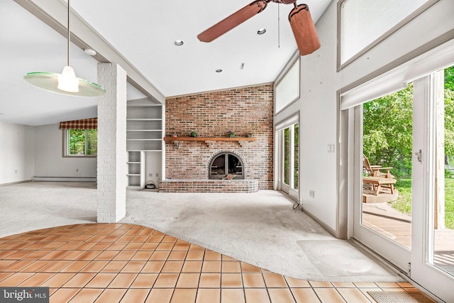 unfurnished living room featuring light carpet, a ceiling fan, built in shelves, a fireplace, and a baseboard radiator