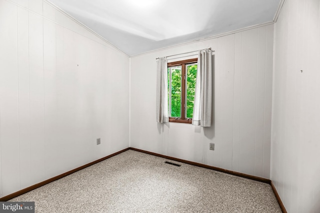 spare room featuring carpet floors and baseboards