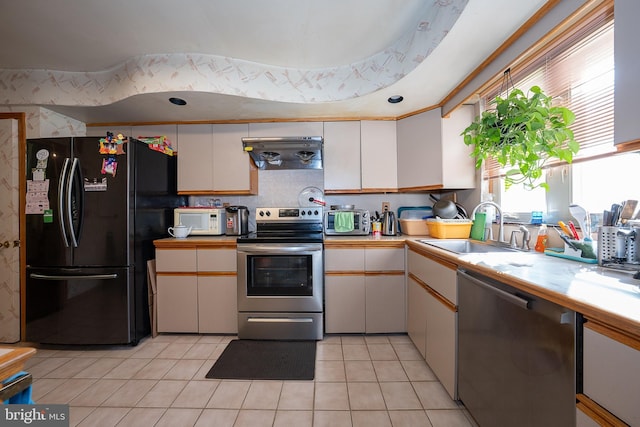 1200 Gainsboro Rd, Bala Cynwyd, PA 19004 - kitchen featuring appliances with stainless steel finishes, a sink, under cabinet range hood, and plenty of natural light