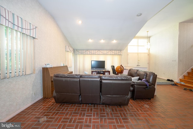 1200 Gainsboro Rd, Bala Cynwyd, PA 19004 - living area featuring brick floors, vaulted ceiling, and stairs