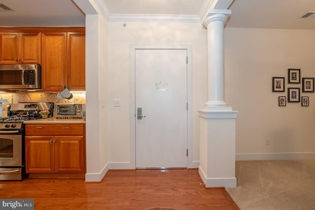 1322 Meridian Blvd Unit 1322, Warrington, PA 18976 - kitchen with stainless steel appliances, decorative columns, baseboards, tasteful backsplash, and ornamental molding