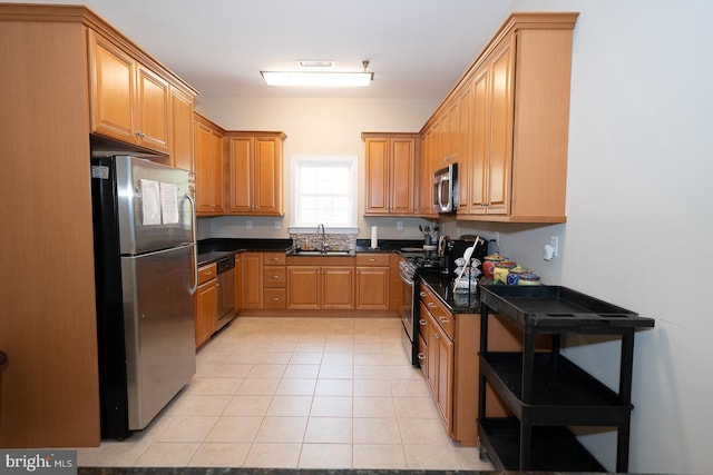 1322 Meridian Blvd Unit 1322, Warrington, PA 18976 - kitchen with appliances with stainless steel finishes, a sink, light tile patterned flooring, dark countertops, and brown cabinets