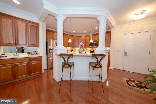 1322 Meridian Blvd Unit 1322, Warrington, PA 18976 - kitchen featuring decorative columns, stainless steel appliances, brown cabinets, and crown molding