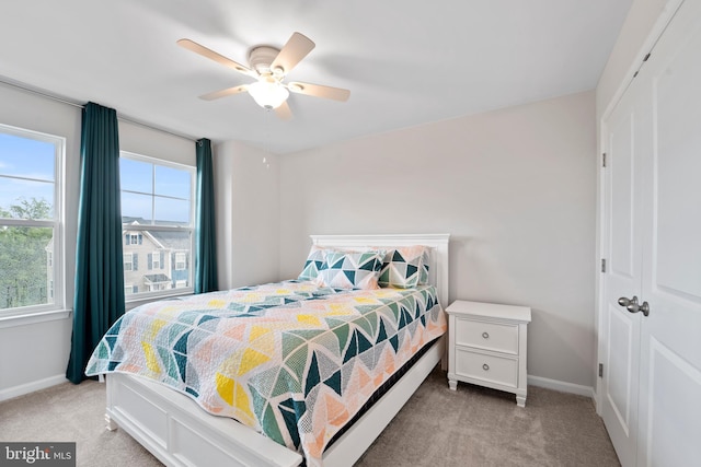 18216 Summit Pointe Dr, Triangle, VA 22172 - bedroom featuring light colored carpet, a closet, baseboards, and a ceiling fan