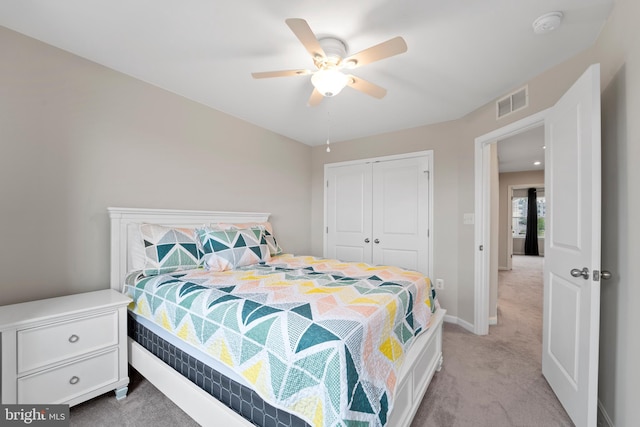 18216 Summit Pointe Dr, Triangle, VA 22172 - bedroom featuring a closet, light colored carpet, baseboards, and a ceiling fan