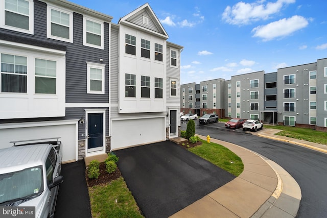 18216 Summit Pointe Dr, Triangle, VA 22172 - view of property with stone siding, a garage, and asphalt driveway