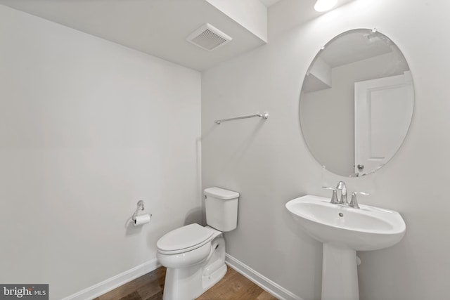 18216 Summit Pointe Dr, Triangle, VA 22172 - half bathroom featuring wood finished floors, baseboards, and toilet