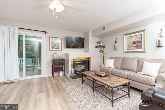 980 Roundhouse Ct Unit 32, West Chester, PA 19380 - living area with wood finished floors, a ceiling fan, a glass covered fireplace, and baseboards