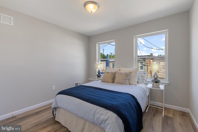 921 N Rose St, Baltimore, MD 21205 - bedroom with baseboards and wood finished floors