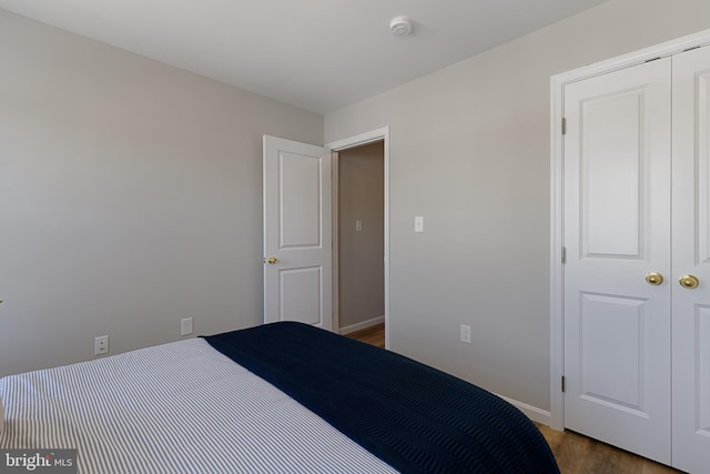 921 N Rose St, Baltimore, MD 21205 - unfurnished bedroom featuring wood finished floors and baseboards