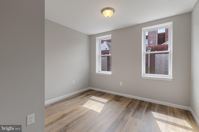 921 N Rose St, Baltimore, MD 21205 - empty room with wood finished floors and baseboards