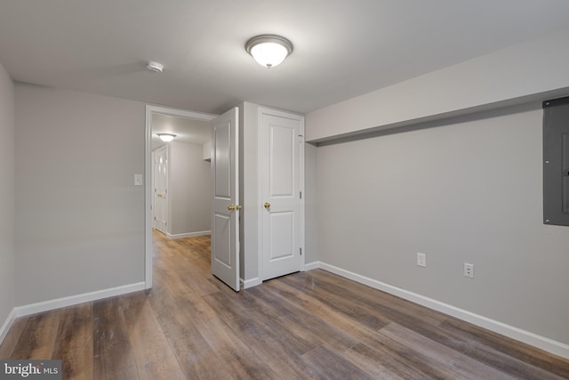 921 N Rose St, Baltimore, MD 21205 - basement with wood finished floors, baseboards, and electric panel