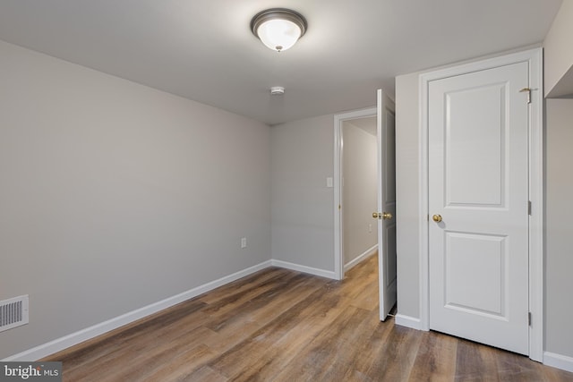 921 N Rose St, Baltimore, MD 21205 - unfurnished bedroom with wood finished floors and baseboards
