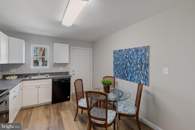 921 N Rose St, Baltimore, MD 21205 - kitchen with black appliances, a sink, light wood-type flooring, and white cabinetry