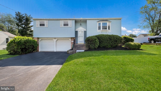 949 Marshall Dr, Warminster, PA 18974 - raised ranch featuring driveway, a front lawn, a garage, and brick siding