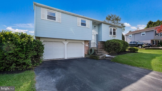 949 Marshall Dr, Warminster, PA 18974 - raised ranch with an attached garage, driveway, a front lawn, and brick siding