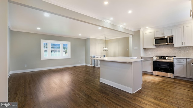 949 Marshall Dr, Warminster, PA 18974 - kitchen with appliances with stainless steel finishes, light countertops, a center island, decorative backsplash, and ornamental molding