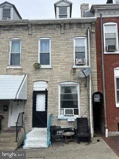 1111 Green St, Reading, PA 19604 - townhome / multi-family property featuring brick siding, entry steps, and cooling unit