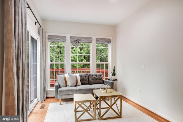 13943 Lullaby Rd, Germantown, MD 20874 - living room with healthy amount of natural light, light wood finished floors, and baseboards