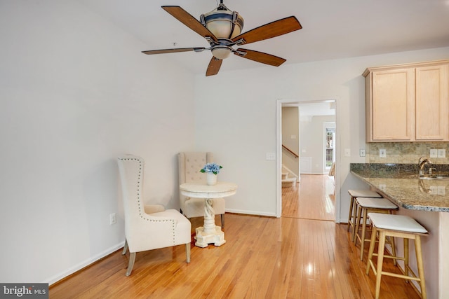13943 Lullaby Rd, Germantown, MD 20874 - living area with light wood finished floors, stairs, baseboards, and a ceiling fan