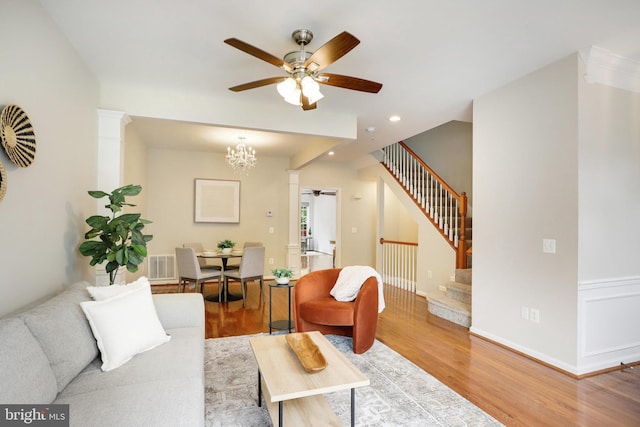 13943 Lullaby Rd, Germantown, MD 20874 - living room with a ceiling fan, stairway, decorative columns, wood finished floors, and recessed lighting