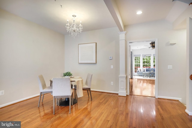13943 Lullaby Rd, Germantown, MD 20874 - dining space featuring decorative columns, light wood finished floors, a ceiling fan, a chandelier, and baseboards