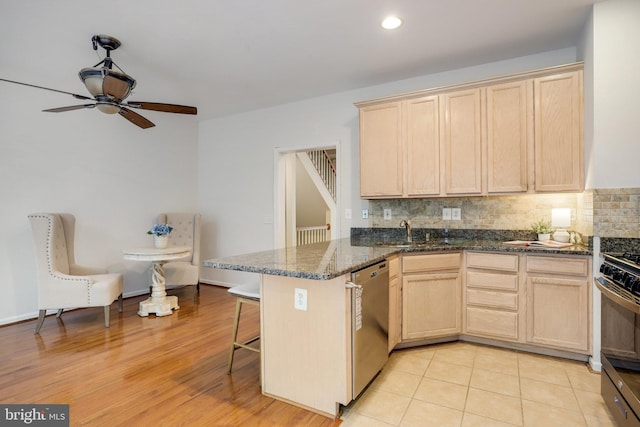 13943 Lullaby Rd, Germantown, MD 20874 - kitchen featuring light brown cabinets, appliances with stainless steel finishes, a peninsula, tasteful backsplash, and a sink