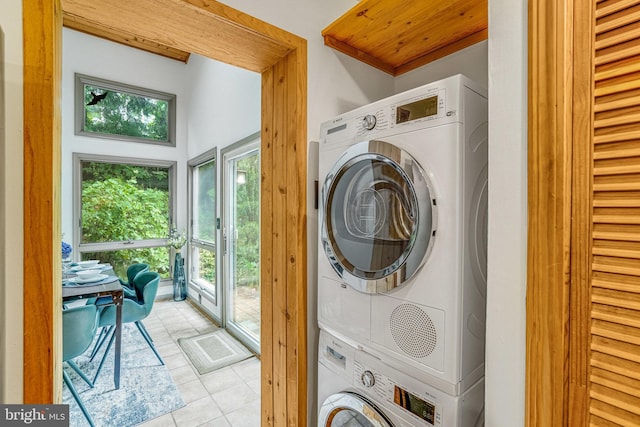 2005 S Quincy St, Arlington, VA 22204 - washroom featuring stacked washing machine and dryer, light tile patterned flooring, and healthy amount of natural light