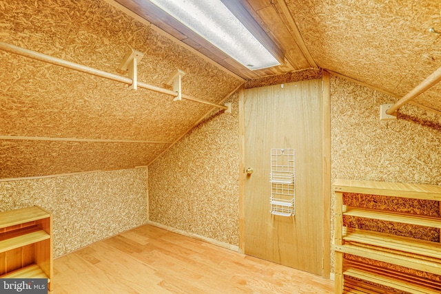 2005 S Quincy St, Arlington, VA 22204 - additional living space with lofted ceiling, wood finished floors, and wallpapered walls