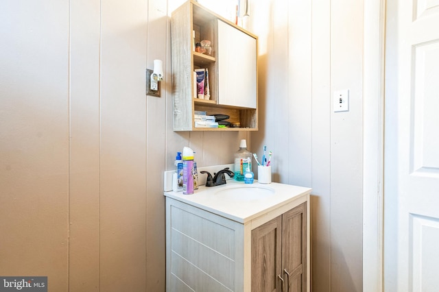 bathroom with vanity and a decorative wall