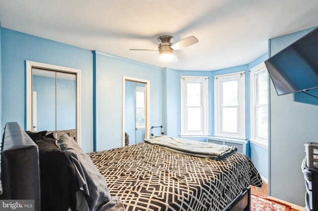 bedroom with a closet, a ceiling fan, and baseboards