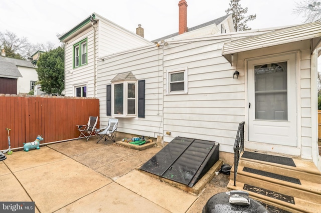 back of house featuring entry steps and a patio area