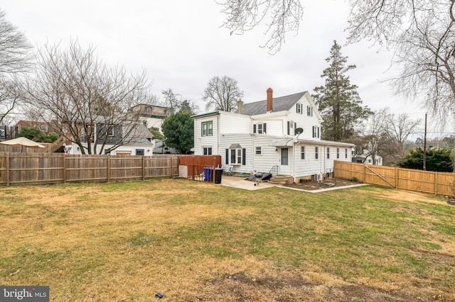 back of property with a patio area, entry steps, and a chimney
