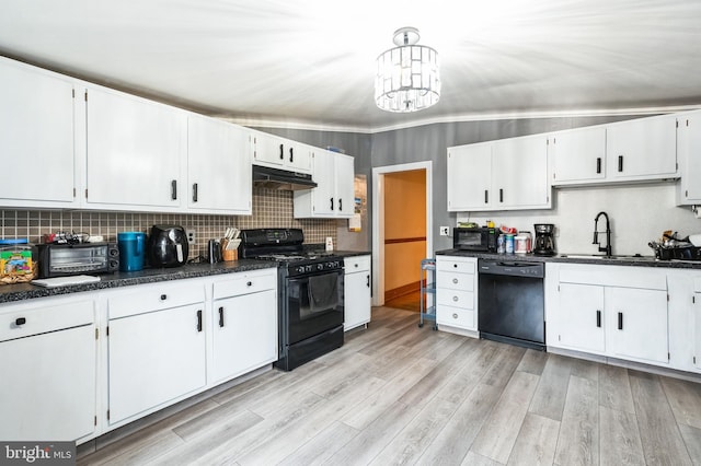 kitchen featuring black appliances, under cabinet range hood, a sink, backsplash, and light wood-style floors